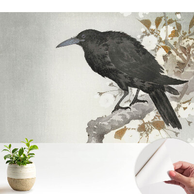 Luxusná tapeta Jemný havran na pozadí kvitnúcich konárov