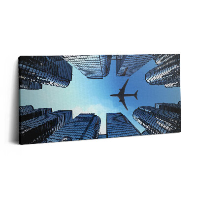Fotoobraz na plátne 100x50 Lietadlo nad mestskými mrakodrapmi.