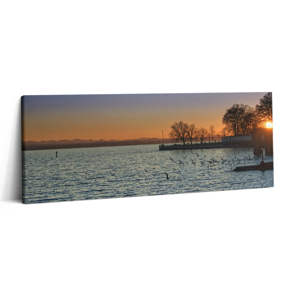 Obraz na plátne 125x50 Západ slnka nad jazerom a stromami