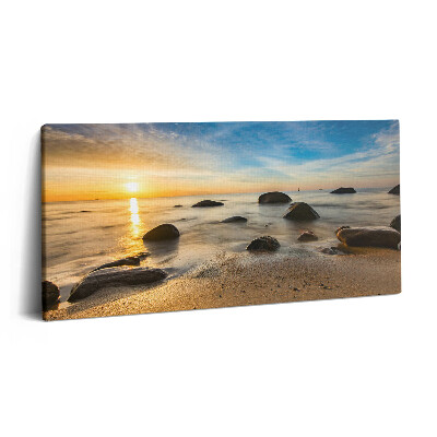 Obraz na plátne 140x70 Západ slnka nad skalnatou plážou